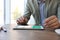 Man using modern tablet with switched on VPN at wooden table in office, closeup