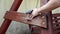 Man using sand paper on wooden bench