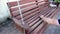 Man using sand paper on wooden bench