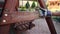 Man using sand paper on wooden bench