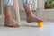 Man using silicone ball for foot massage during long sedentary work, legs close-up.