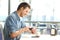 Man using a smartwatch in a coffee shop