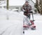 Man using snowblower in deep snow