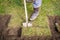 Man using spade for old lawn digging, gardening concept