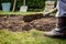 Man using spade for old lawn digging, gardening concept