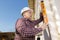 Man using spirit level on exterior wall