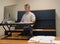 Man using stand up desk in office for good health