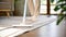 A man using stick vacuum cleaner to clean the carpet in living room. house cleaning