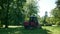 A man using a tractor grass cutter at Botanical Garden