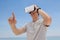 Man using vr headset against the blue sky