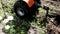 A man using a walk-behind tractor makes furrows in the ground for planting potatoes, rural economy, outdoor