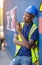 Man Using Walkie Talkie At Container Terminal, Industrial worker is controlling container loading