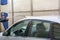 Man Using Water Pressure Machine to Wash a Car