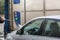 Man Using Water Pressure Machine to Wash a Car