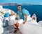 Man on vacation Greece visisting Oia Santorini, guy on holiday in Greece on a luxury trip to Oia whitewashed village