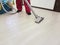 The man vacuums the floor cleaning equipment