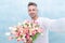 man with valentines tulips make selfie. man with valentines tulips in studio.