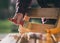 Man varnishing wooden chair in garden