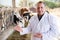 Man veterinarian inspecting cows