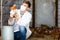 Man veterinarian in mask taking look at chicken