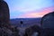 A man with a video camera meets dawn on Mount Moses, Egypt