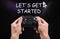 Man with video game controller and phrase LET`S GET STARTED against night sky
