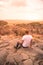 Man at view point looking to the bush savannah of Serengeti at sunset, Tanzania - Safari in Africa