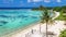 Man at viewpoint tower at the beautiful beach with palm trees at tropical island Manadhoo capital of Noonu atoll