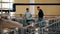 Man vintner and winemaker inspecting equipment for production wine at factory