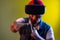 Man in virtual reality glasses on head playing fighting game, holding clenched fists up to camera.