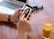 Man visiting dating site via smartphone at table, closeup