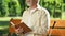 Man with visual impairment smiling reading book in Braille, pleasure moments