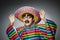 Man in vivid mexican poncho against gray