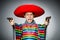 Man in vivid mexican poncho holding handgun