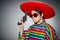 Man in vivid mexican poncho holding handgun