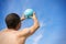 A man with a volleyball against the blue sky close-up.  The concept of an active lifestyle