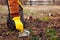 Man volunteer cleaning up the trash in park. Picking up rubbish outdoors. Ecology and environment concept