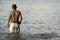 Man wading in lake or sea