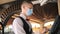 Man or waiter in medical mask at counter with cashbox working at bar or restaurant