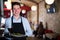 Man waiter with serving tray meeting restaurant guests