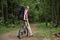 The man, waiting for friends on a country road in the forest.