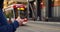 Man waiting tram, engrossed smartphone. Scene depicts urban life, with focus smartphone use. Man tram stop scrolling