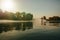 Man wakeboarding on lake at sunset