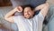 Man Waking Up Lying In Bed At Home, Above-View, Panorama