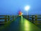 Man walk in autumn mist on wooden pier above sea. Depression, dark atmosphere.