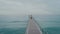 Man walk on infinity endless wooden pier or bridge