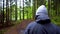 Man on Walk in Nature. Walking in the mountain deep forest. Boy with a hat walking in the woods. Gimbal Head Tracking Shot. Hikers