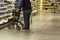 Man with a walker for elderly people shopping for groceries in a supermarket during coronavirus covid-19 pandemic