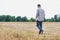 Man walking alone across a field with his head held low