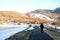 A man walking alone along a snow lined Winter path